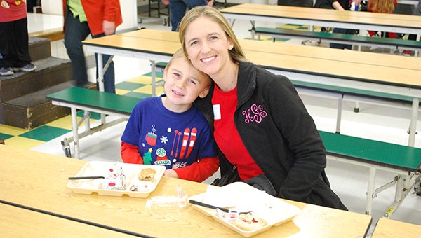 Helena Elementary School first grader Jack Goodwin and his mom enjoy breakfast with Santa on Friday, Dec. 4 in the school cafeteria. (Reporter Photo/Graham Brooks)