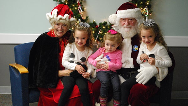 Ava, Ana and Amilia Posey have their picture made with Santa and Mrs. Claus on Monday, Dec. 14 at the Jane B. Holmes Public Library in Helena. (Reporter Photo/Graham Brooks)