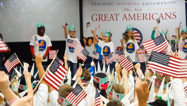 Second-graders at Forest Oaks Elementary School sing a song during their Super Citizen Program graduation on Dec. 11. (Reporter Photo/Emily Sparacino)