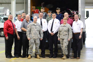 Hoover Fire Department officials and members of the Alabama National Guard get together after loading the last batch of toys for Operation Santa's Helper on Dec. 23. (Reporter Photo/Emily Sparacino)