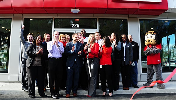 Verizon Wireless employees and managers celebrate the grand opening of the company’s new store in the South Promenade shopping center on Dec. 3. (Reporter Photo/Neal Wagner)