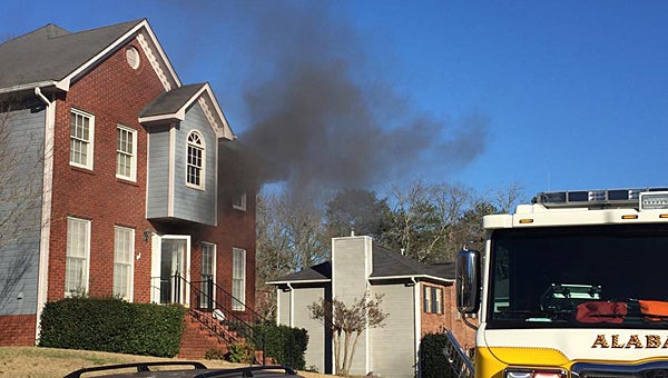 Alabaster firefighters work to extinguish a fire at a residence in Cambridge Pointe on Jan. 5 after one of the city’s police officers helped a man climb to safety from the second floor. (Contributed)
