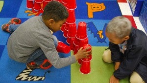 Students in Amy Kleback’s class work together to build a structure with 100 red cups. (Reporter Photo/Molly Davidson) 