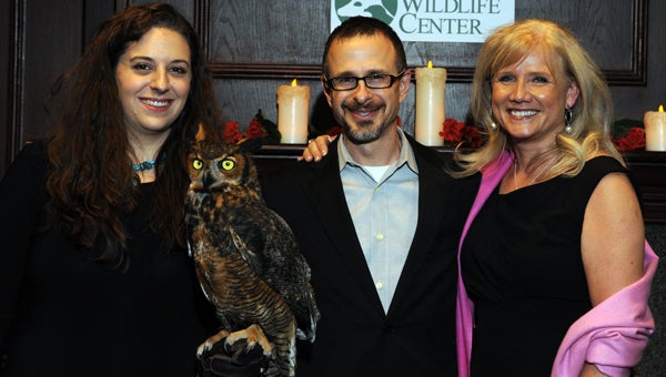Attendees of Alabama Wildlife Center’s Wild About Chocolate event visit with a great-horned owl educational ambassador. (Contributed) 