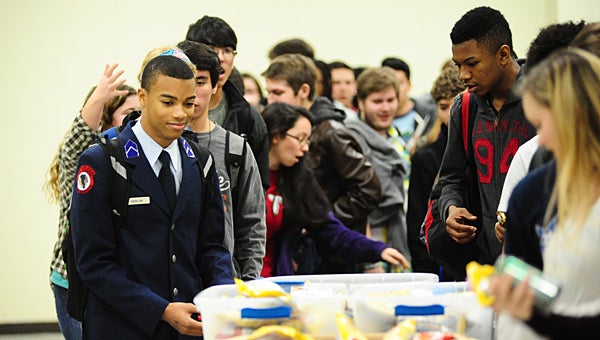 Thompson High School students line up at a table packed with snacks and drinks during a Jan. 13 honor roll party in the school’s cafeteria. (Reporter Photo/Neal Wagner)
