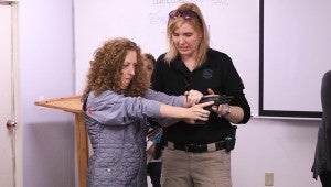 Before heading out to the range, the women spent an hour in the classroom as Beth Alcazar prepared them to safely handle a pistol. (For the Reporter / Dawn Harrison)