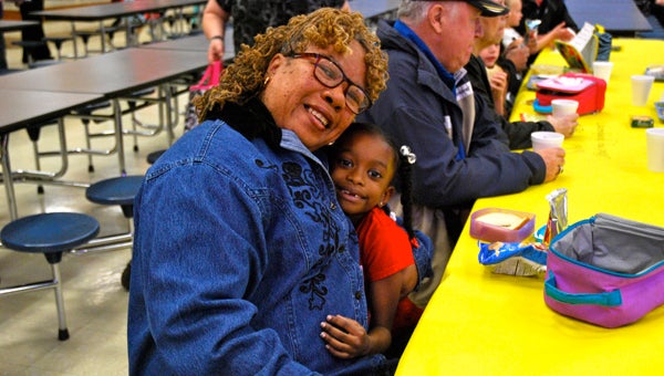 Roselia and her granddaughter Caryn enjoy lunch together at IES Grandparents Day on Feb. 19. (Reporter Photo/Molly Davidson)