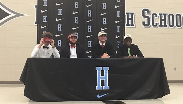 From left, HHS football players Diondre Sackreiter, Brody Rhodes, Brett Granger and Phildon Dublin sign their National Letters of Intent at Helena High School on Wednesday, Feb. 3. (Reporter Photo/Graham Brooks)