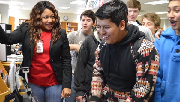 Ninth-graders learn about surprise expenditure, such as tag renewals, as they spin the “That’s Life” wheel during the Greater Shelby County Chamber’s “Keeping it Real” program. (Reporter photo / Jessa Pease) 