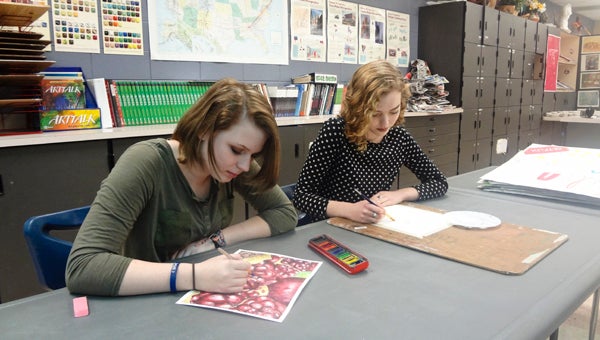 Chelsea High School students Kaitlyn Avery and Kristen Hamby work on projects in art teacher Max Newton's class. Avery and Hamby are among 15 students that will have artwork displayed in this year's State Superintendent's Visual Arts Exhibit in Montgomery. (Reporter Photo/Emily Sparacino)