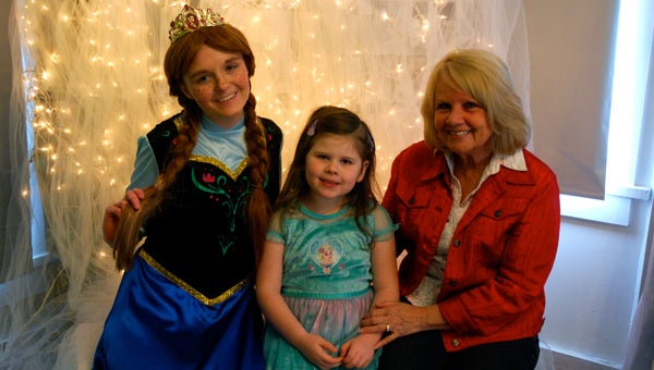 : Emily Reed, as Princess Anna, with tea party guests Bella and Erline Alexander. (Reporter Photo/Molly Davidson)