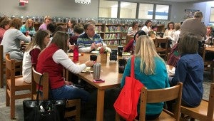 Teachers enjoy lunch together in the IES library. While teachers ate, parent volunteers supervised their classrooms. (Reporter Photo/Molly Davidson)