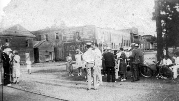 Waiting on the train. A rare 1940s view of the rear of Helena's Main Street stores can be observed in this photograph taken during a Pitts family reunion. The crowd was milling around the front yard of C.T. Davidson's home. After C.T.'s death, his son, Joseph Squire Davidson, took up residence in the home place with his wife, Emmie Pitts Davidson. (Contributed/City of Helena Museum)