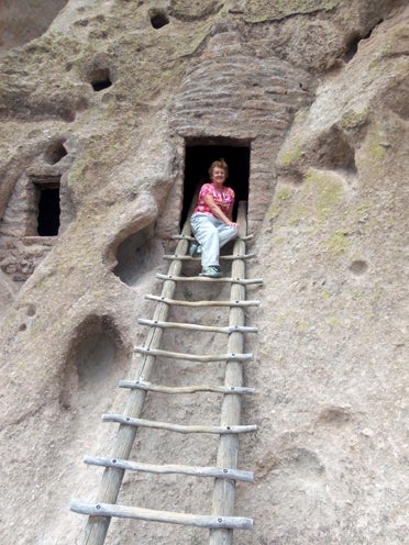 Valya Mobley sits 140 feet above the floor of the Frijoles Canyon in Alcove House of Bandelier National Monument. Alcove House, home to ancestral Pueblo people, is reached via four wooden ladders and a number of stone stairs. (Contributed)