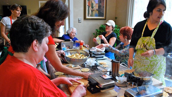 Volunteers gather to make pizzelle, a traditional Italian cookie, for the Feast of St. Mark Italian Food Festival on March 12. (Reporter Photo/Molly Davidson)