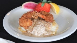 Fresh fish is a staple at Mikey’s Grill. Pictured is one of the most popular dishes, sautéedsnapper topped with pecan fried shrimp on a pecan butter sauce. (For the Reporter/Dawn Harrison)