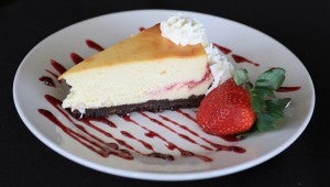 Mikey’s Grill serves desserts handmade by Michael and Melissa Lee’s mother, such as the strawberry cheesecake pictured above. (For the Reporter/Dawn Harrison)