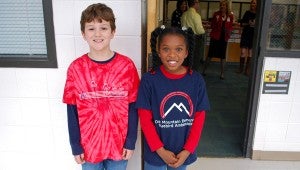 Luke Marvin and Alana Jackson, both OMES third graders, stand outside the school's library, ready to guide visitors to the school's first Leadership Day on March 4. (Reporter Photo/Molly Davidson)