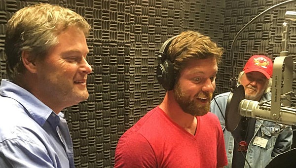 Former Calera High School and current Thompson High School engineering teacher Brian Copes, left, helps Noah Galloway, center, during a recent recording session for a documentary on Copes’ Calera students. (Contributed)