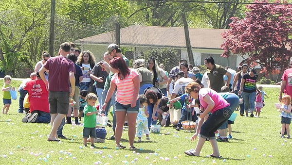 Families seek out candy-filled eggs during Alabaster Church of God’s annual Easter egg hunt last year. (Contributed)