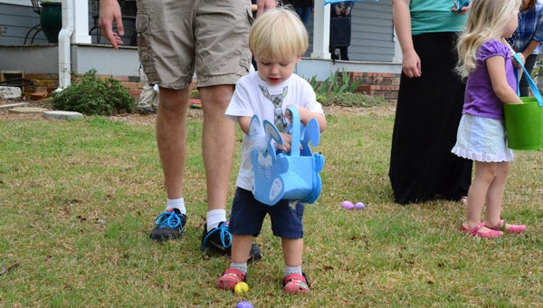 Maverick Ferris drops an Easter egg he found at the Chelsea Library into his basket. (Reporter Photo/Emily Sparacino)
