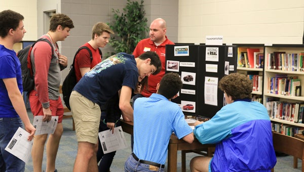 Steven Coggin with Alabama Power Company talks to students about transportation costs, including vehicle and fuel expenses, during the Keeping It Real program at Chelsea High School on March 18. (For the Reporter/Dawn Harrison)