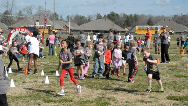Pre-K and kindergarten students at Meadow View Elementary School run laps on the front lawn of the school during the second annual MVES Warrior Run on March 9. (Reporter Photo/Emily Sparacino)