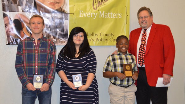 Dalton Stern, Ashlin Hope and Jeffery Gaiters pose with Judge Jim Kramer after receiving Character in Action Awards at a Shelby County Children’s Policy Council meeting. (Reporter photo/Jessa Pease) 