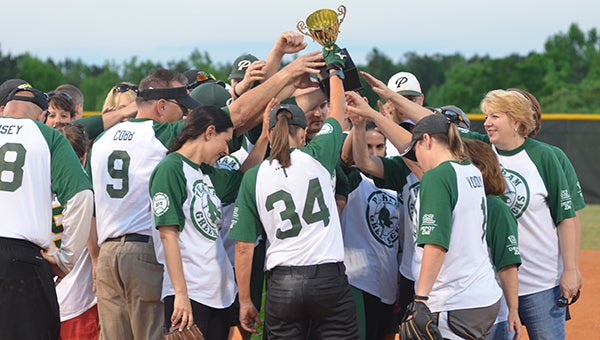 The Pelham High School faculty members hoist a trophy after defeating Helena in the Second Annual Faculty Softball game on Tuesday, April 26. (Reporter Photo/Graham Brooks)