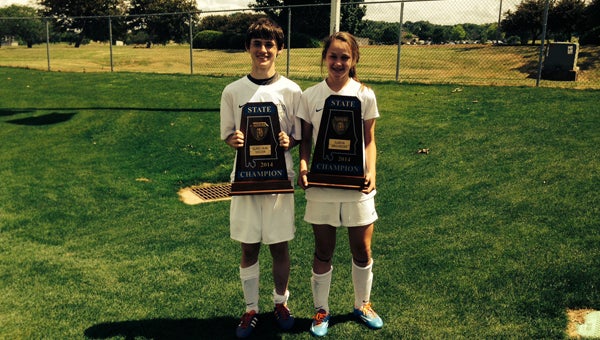 Austin and Julia Pack, shown here holding state soccer titles they won in 2014, make for an incredibly talented set of soccer siblings. (Contributed)