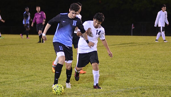 Helena’s Erik Canales (11) fights for the ball in the first half in an area game against Montevallo. Canales finished with one goal in the game. (Reporter Photo/Graham Brooks)
