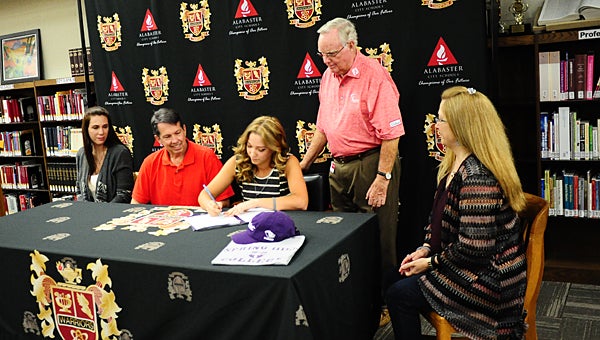 THS senior Katelyn Wood, center, signs a golf scholarship with Spring Hill College during an April 18 ceremony in the school’s library. She is joined by, from left, her step-mother McKenzie Wood, father Roger Wood, golf instructor Hank Johnson and mother, Karen Leach. (Reporter Photo/Neal Wagner)