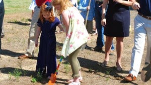 Two young parishioners help break ground for the church’s multimillion-dollar expansion on May 22. (Reporter Photo/Molly Davidson)