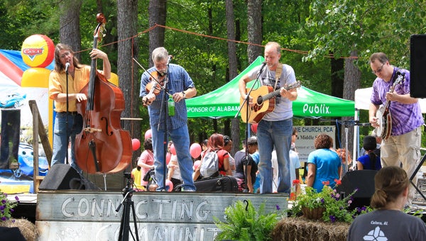 Bluegrass bands entertain guests of Calera’s Strawberry Festival as they peruse more than 50 vendors and enjoy fresh, locally grown strawberries. (For the Reporter/Dawn Harrison) 