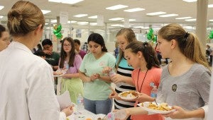 Sixth through eighth grade students peruse various sweet and savory healthy options. 