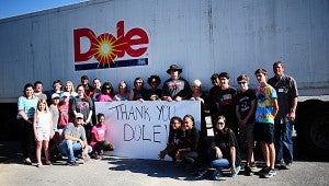 The group shows its appreciation to the Dole company for shipping the items to Honduras. (Reporter Photo/Neal Wagner)