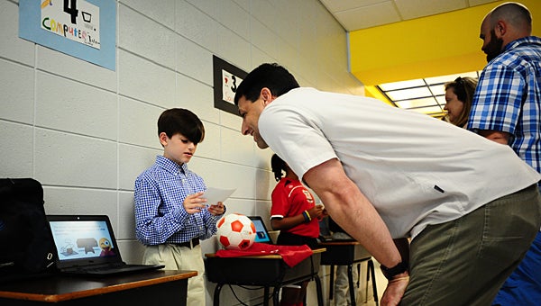 Meadow View Elementary School gifted student Evan Caldarello, left, describes what it takes to become a computer scientist during the school’s “Future me” fair on May 13. (Reporter Photo/Neal Wagner)
