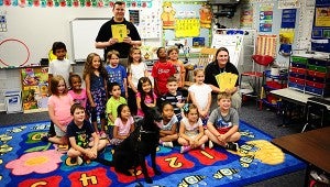Alabaster police officer Hunter Hammonds leads Micco, left, during a visit to Julie Howanitz’ classroom at Meadow View Elementary School on May 19. (Reporter Photo/Neal Wagner)