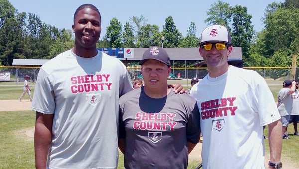 Toby Wilson, center, is joined by friends Bobby Madison and Ricky Ruston on May 14 during the closing ceremonies for youth baseball. Wilson has received an outpouring of community support during his battle with Lymphoma. (Contributed)