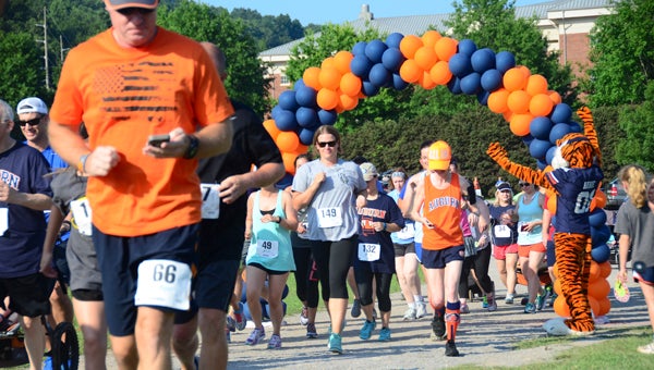 Auburn University mascot Aubie, right, cheers runners at the starting line of the 2016 Greater Birmingham Auburn Club Aubie 5K and 1-Mile Fun Run at Veterans Park in Hoover on June 25. (Reporter Photo/Emily Sparacino)