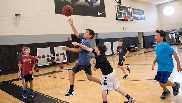 A camper goes up for a shot during a summer basketball camp the week of June 27. The camp was open to kids in grades 1-8. (Reporter Photo/Keith McCoy)