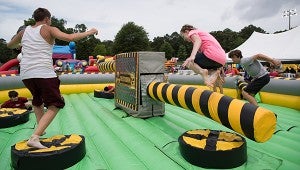 Children enjoy inflatable games in the KidsFest area on June 4. (Reporter Photo/Keith McCoy)