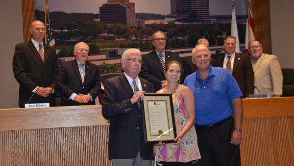 Hoover Mayor Gary Ivey presents a proclamation recognizing July as Parks and Recreation Month in the city to parks and recreation employee Morgan VonBehren and board member Randy Lott at a July 5 City Council meeting. (Reporter Photo/Emily Sparacino)