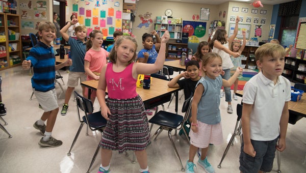 Carol McLaughlin's class at Greystone Elementary School stretches their legs by dancing and singing songs on Aug. 11, the first day of school. (Photos by Keith McCoy)