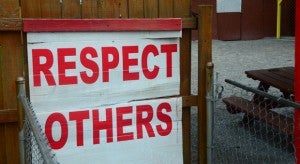 A sign reading respect others hangs right outside of the door to the outdoor area. (Reporter photo/Alec Etheredge)