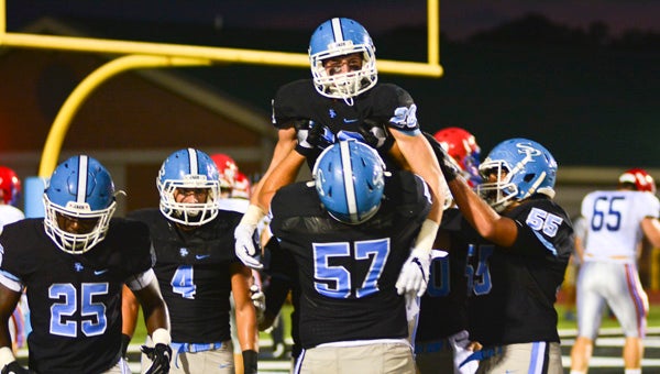 Teammates celebrate with Spain Park's Thomas Jordan, No. 28, after a touchdown reception during a win over Vestavia Hills on Sept. 2 (Photo by Stephen Dawkins)
