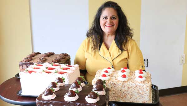 Cynthia Bertolone, owner of Cake Art by Cynthia Bertolone in Pelham, displays several of her cakes. 