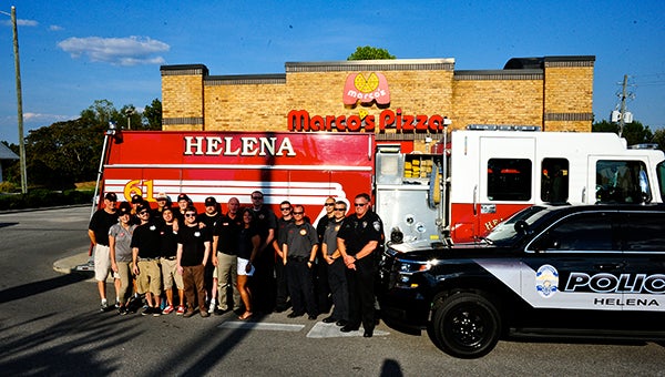 Members of the Marco’s Pizza staff in Helena pose for a photo with Helena Police and Fire Department members. Marco’s will offer free meals to local police, fire and EMT personnel on Sept. 12. (Reporter Photo/Graham Brooks)